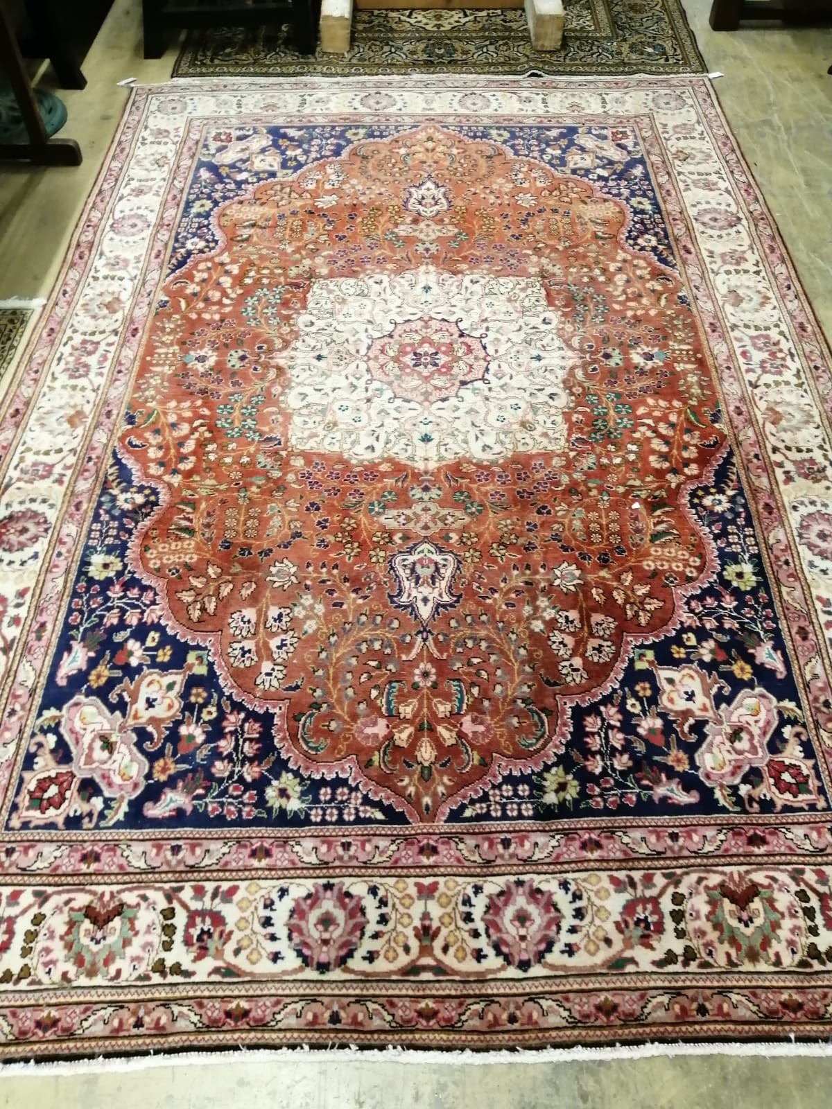 A Persian brick red ground carpet, 307 x 205cm